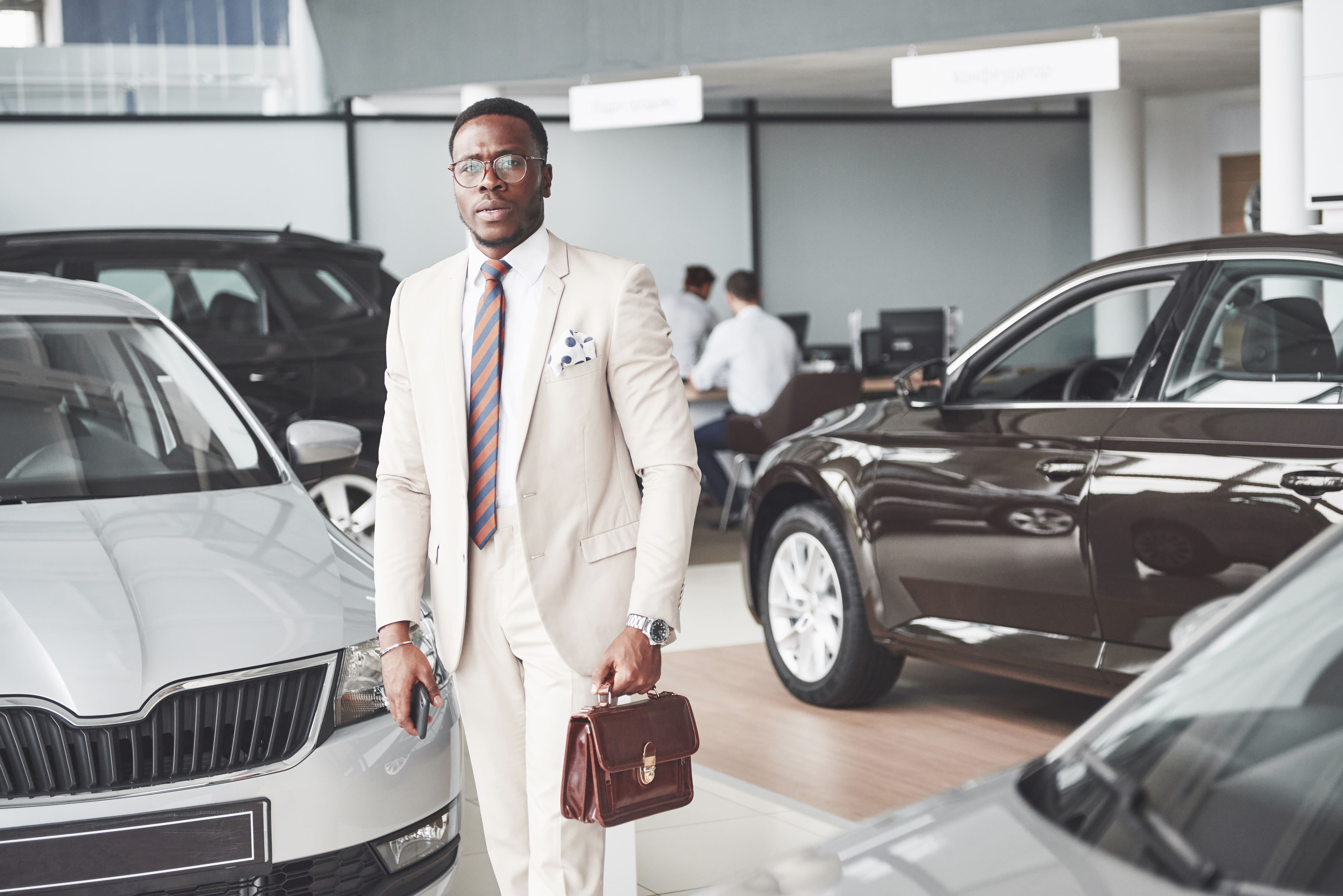 A stylish African couple in an elegant social setting where status is visible but intimacy remains uncertain.